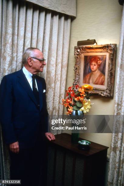 Dr Armand Hammer was an American business manager and owner, most closely associated with Occidental Petroleum, photographed at home looking at one...