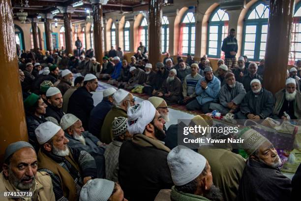 Kashmiri Muslim devotees pray at the shrine of the Sufi saint Sheikh Hamza Makhdoom during a festival on November 14, 2017 in Srinagar, the summer...