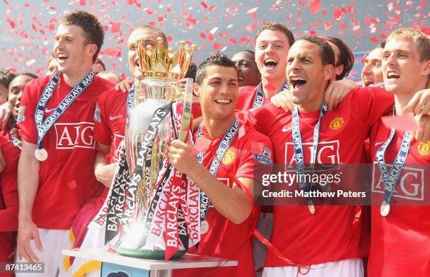 Cristiano Ronaldo of Manchester United celebrates with the Premier League trophy after the Barclays Premier League match between Manchester United...