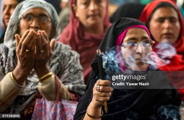 Kashmiri Muslim women devotees pray at the shrine of the Sufi saint Sheikh Hamza Makhdoom during a festival on November 14, 2017 in Srinagar, the...