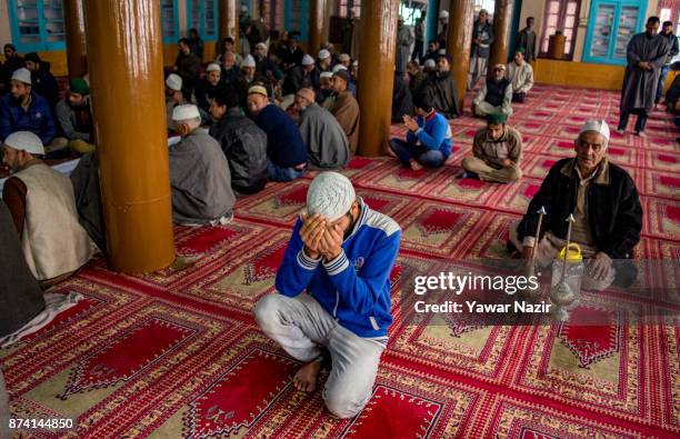 Kashmiri Muslim devotees pray at the shrine of the Sufi saint Sheikh Hamza Makhdoom during a festival on November 14, 2017 in Srinagar, the summer...