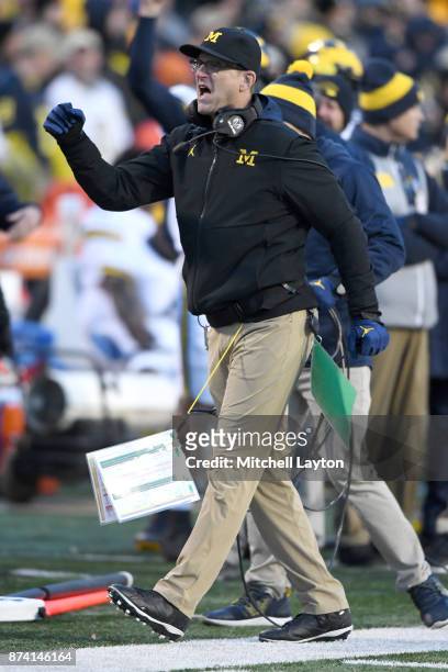 Head coach Jim Harbaugh of the Michigan Wolverines celebrates a touchdown during a college football game against the Maryland Terrapins at Capitol...