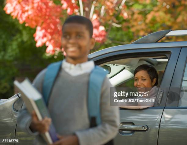 african mother dropping son off at school - car arrival stock pictures, royalty-free photos & images