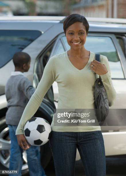 african mother holding soccer ball - soccer mom stock pictures, royalty-free photos & images