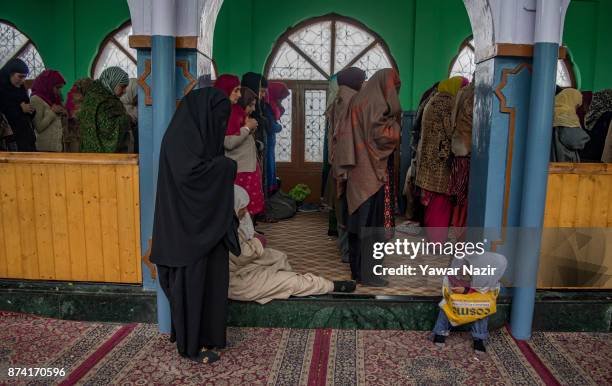 Kashmiri Muslim women devotees prays at the shrine of the Sufi saint Sheikh Hamza Makhdoom during a festival on November 14, 2017 in Srinagar, the...