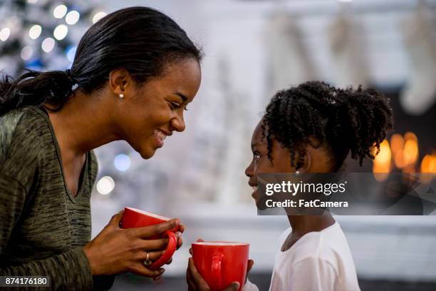 drinking cocoa together - mom drinking coffee with kids stock pictures, royalty-free photos & images
