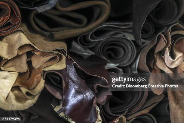 rolls of leather sit stacked at a leather store - gst stock-fotos und bilder