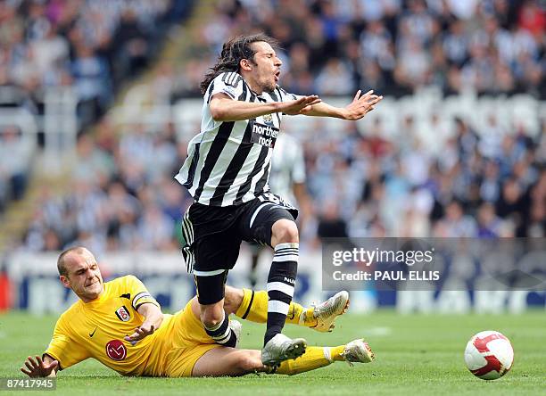 Fulham's English midfielder Danny Murphy tackles Newcastle United's Argentinian midfielder Jonas Gutierrez during their English Premier League...