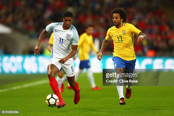 Marcus Rashford of England and Marcelo of Brazil battle for possession during the international friendly match between England and Brazil at Wembley...