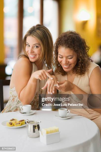 african woman admiring friendâ¿s engagement ring - black women engagement rings stock pictures, royalty-free photos & images