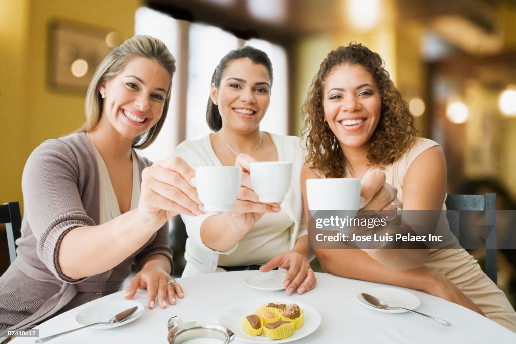 Friends enjoying coffee in cafe