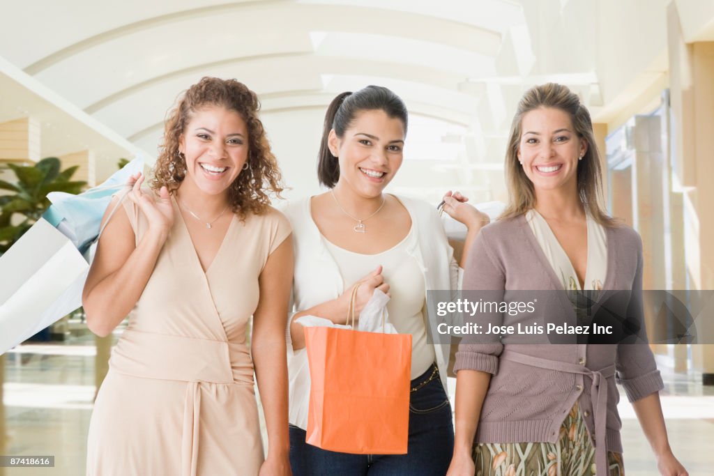 Friends in mall with shopping bags