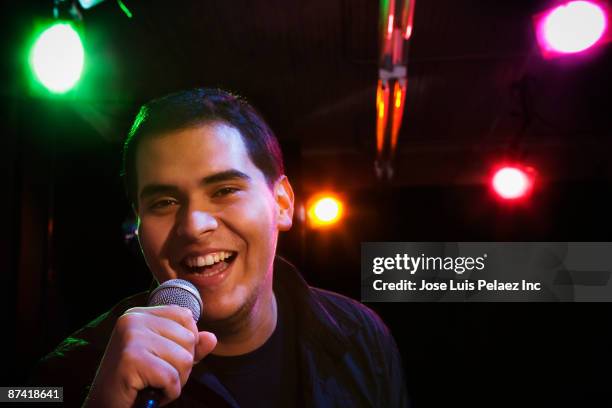 hispanic man singing in nightclub - man open mouth stock pictures, royalty-free photos & images