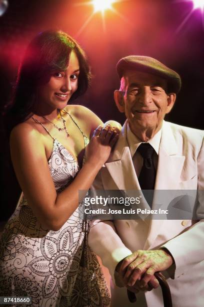 hispanic woman and senior man in nightclub - progress report stock pictures, royalty-free photos & images