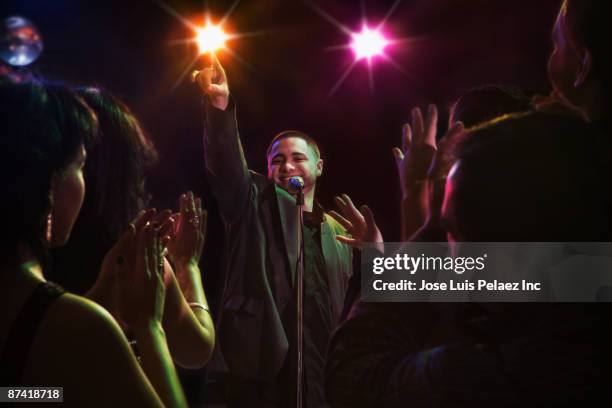 hispanic man singing in nightclub - celebrating the songs voice of gregg allman backstage audience stockfoto's en -beelden