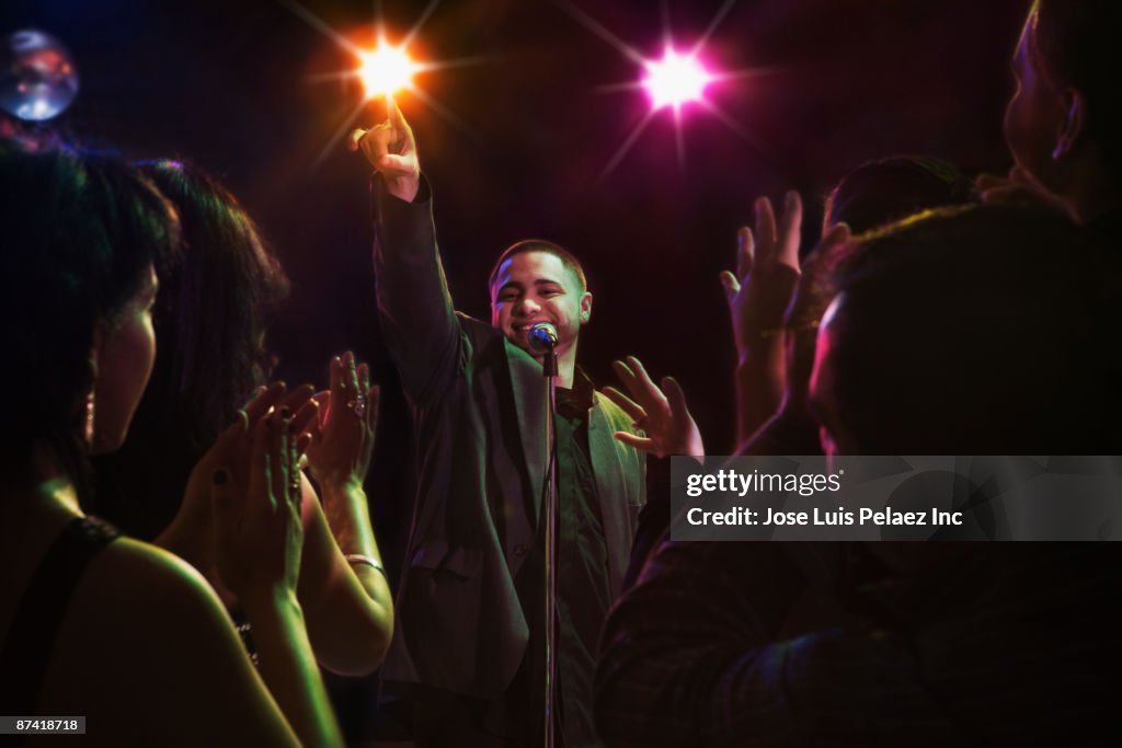 Hispanic man singing in nightclub