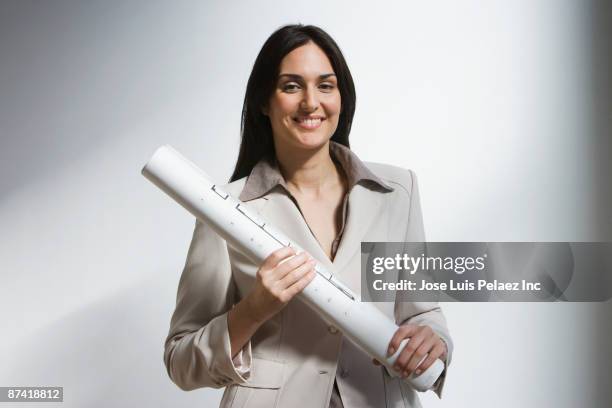 middle eastern businesswoman holding blueprints - architect object stock pictures, royalty-free photos & images