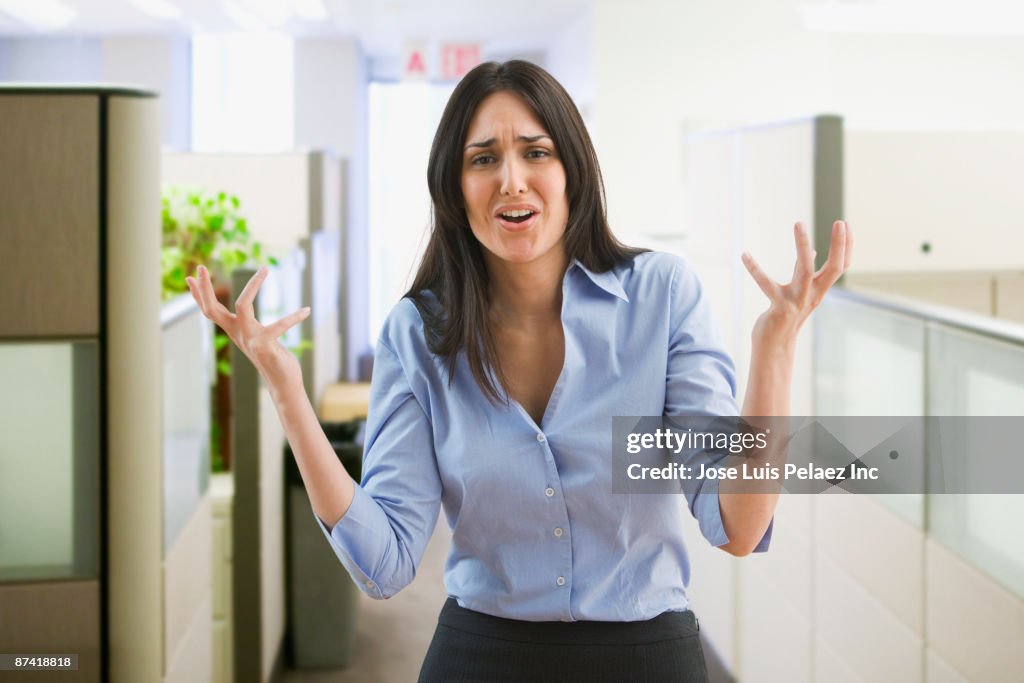 Frustrated Middle Eastern businesswoman in office