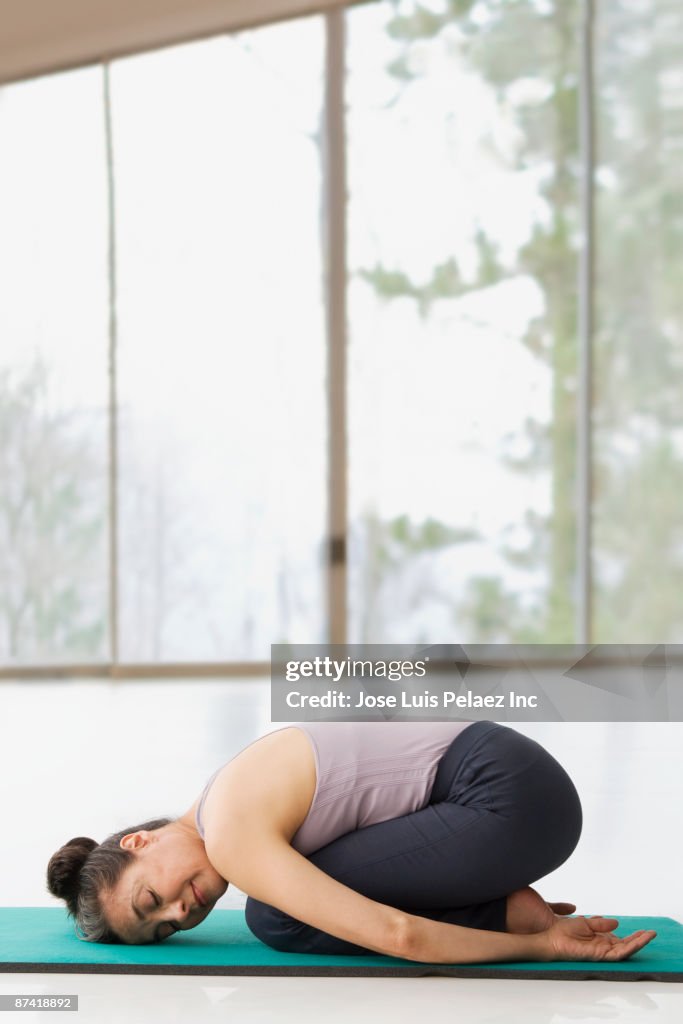 Hispanic woman practicing yoga