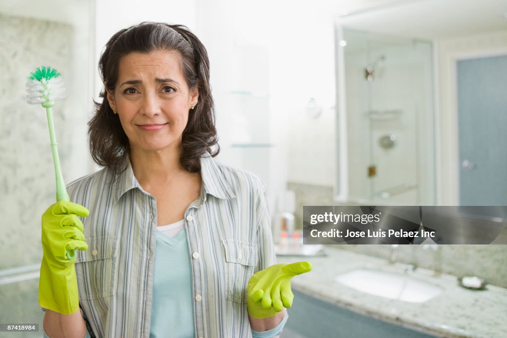 Hispanic woman in rubber-gloves with scrub brush