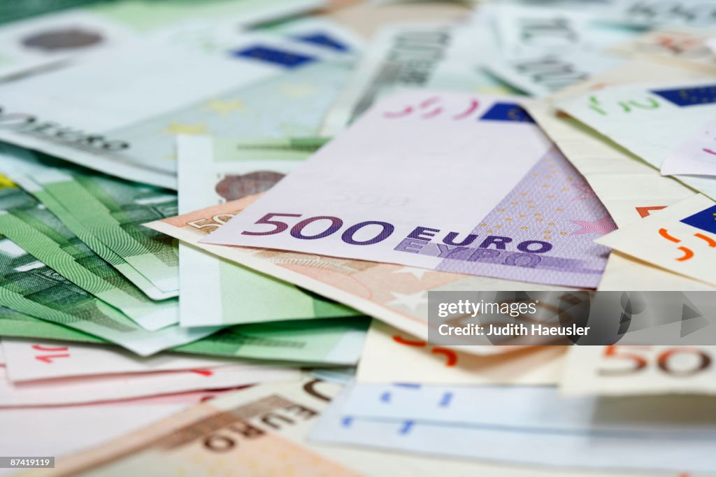 Lots of euro notes on table