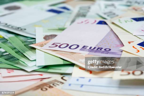 lots of euro notes on table - european union euro note stock pictures, royalty-free photos & images