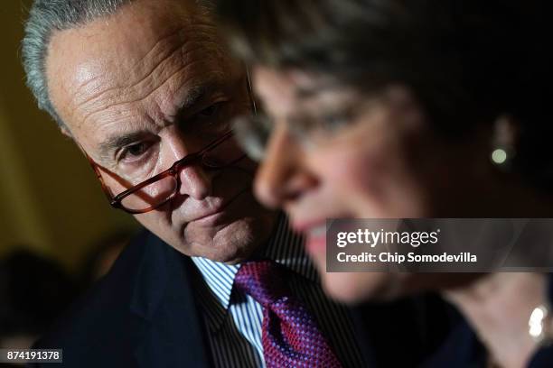 Senate Minority Leader Charles Schumer listens to Sen. Amy Klobuchar as she talks to reporters following the weekly Senate Democratic policy luncheon...