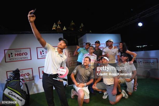 Haotong Li of China takes a selfie with the winners trophy and Francesco Molinari of Italy, Ian Poulter of England, Rafa Cabrera Bello of Spain,...