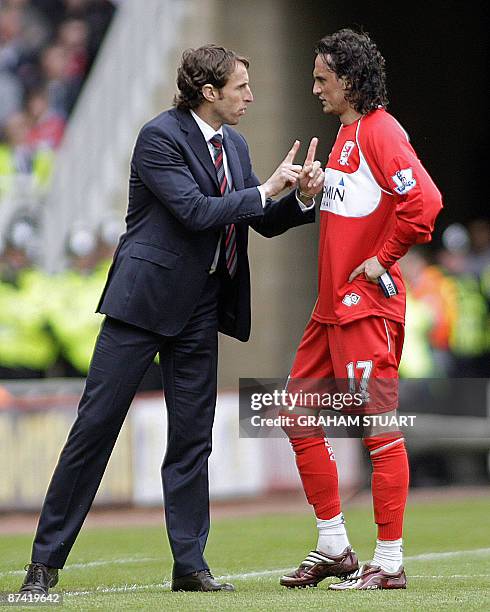 Middlesbrough's English manager Gareth Southgate instructs his Turkish player Tuncay Sanli during the English Premier League football match between...