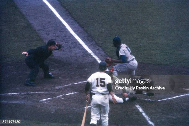 Orlando Cepeda of the San Francisco Giants scores as catcher John Roseboro of the Los Angeles Dodgers was late with the tag as umpire Chris...