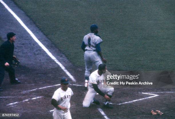 Orlando Cepeda of the San Francisco Giants scores as catcher John Roseboro of the Los Angeles Dodgers was late with the tag as umpire Chris...