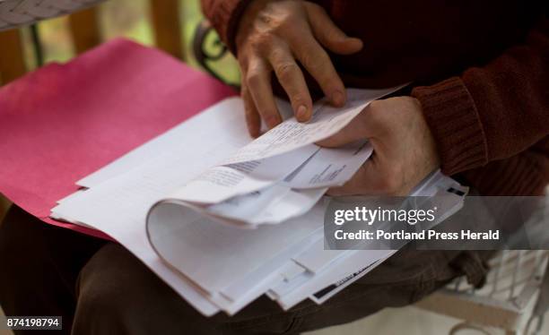 Mark Elwin thumbs though his file of medical records on his screened in porch. Elwin tested positive for anaplasmosis in 2015, was hospitalized, and...