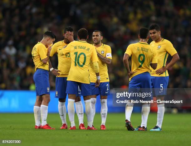 Dani Alves and Neymar lead discussions with the other Brazil players during the Bobby Moore Fund International between England and Brazil at Wembley...