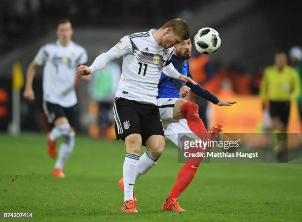 Timo Werner of Germany and Christophe Jallet of France battle for possession during the international friendly match between Germany and France at...