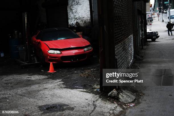 An old car sits behind a mechanic's shop on November 14, 2017 in New York City. According to a new report by the International Energy Agency, global...