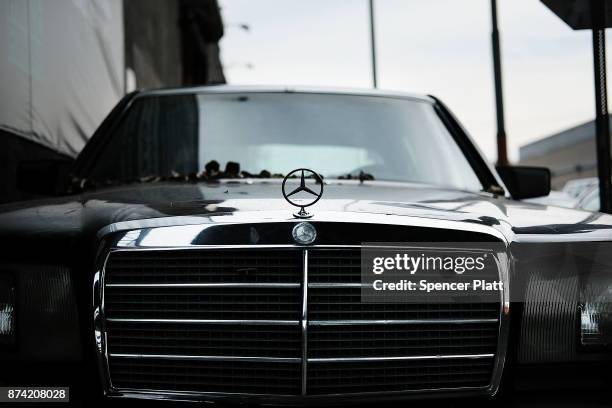 An old Mercedes sits in front of a mechanic's shop on November 14, 2017 in New York City. According to a new report by the International Energy...