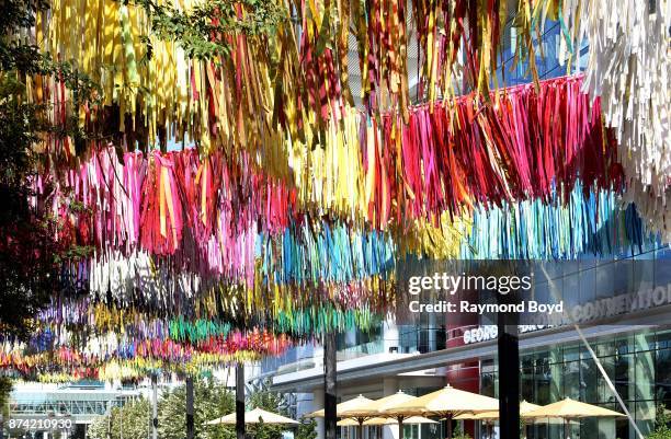 Sunny Sliger and Marianne Newsom of The Color Condition 'Arcade ' art installation consists of strips of tablecloths, shower curtains and painters...