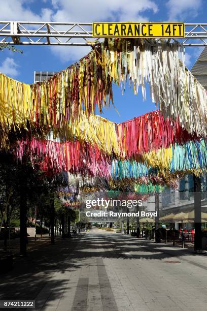 Sunny Sliger and Marianne Newsom of The Color Condition 'Arcade ' art installation consists of strips of tablecloths, shower curtains and painters...