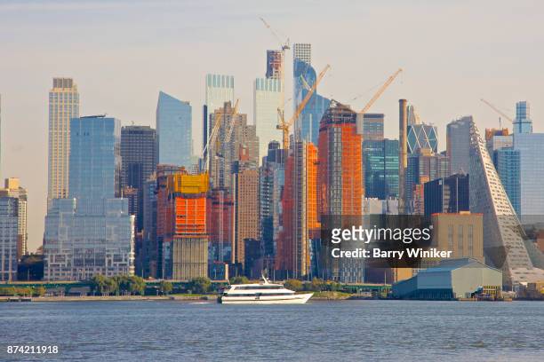 boat on hudson river near towers of midtown west, manhattan, seen from new jersey - barry crane stock pictures, royalty-free photos & images