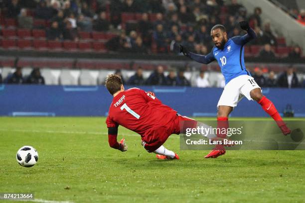 Alexandre Lacazette of France scores his sides second goal past Kevin Trapp of Germany during the international friendly match between Germany and...