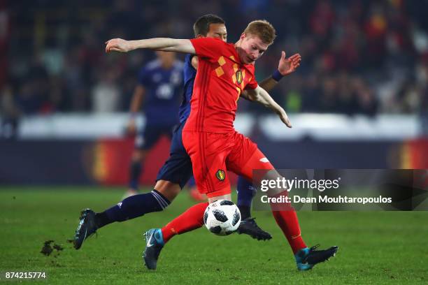 Kevin De Bruyne of Belgium battles for the ball with Yosuke Ideguchi of Japan during the international friendly match between Belgium and Japan held...