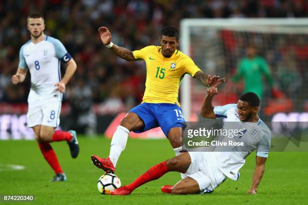 Paulinho of Brazil and Joe Gomez of England battle for possession during the international friendly match between England and Brazil at Wembley...