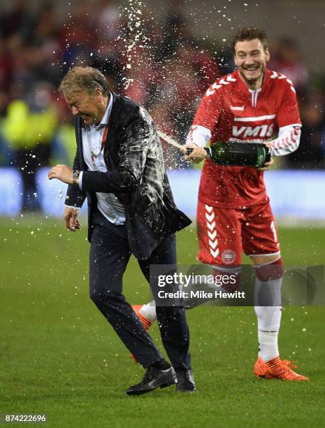 Nicklas Bendtner of Denmark sprays Aage Hareide, Manager of Denmark with champagne after the FIFA 2018 World Cup Qualifier Play-Off: Second Leg...