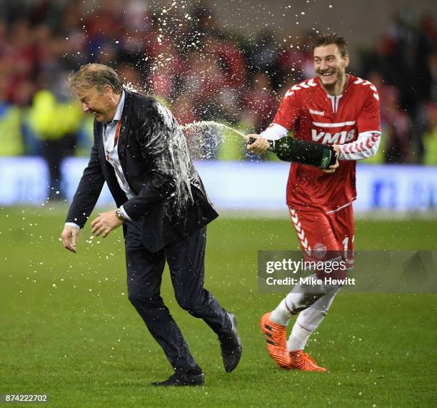 Nicklas Bendtner of Denmark sprays Aage Hareide, Manager of Denmark with champagne after the FIFA 2018 World Cup Qualifier Play-Off: Second Leg...