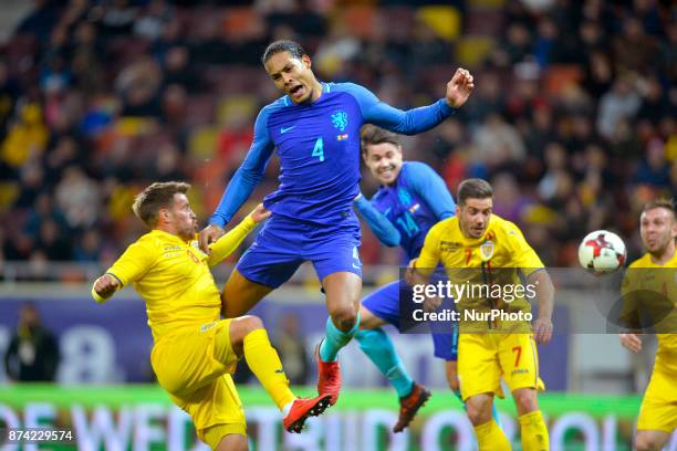 Netherlands's Virgil van Dijk vies Romania's Mihai Pintilii during International Friendly match between Romania and Netherlands at National Arena...