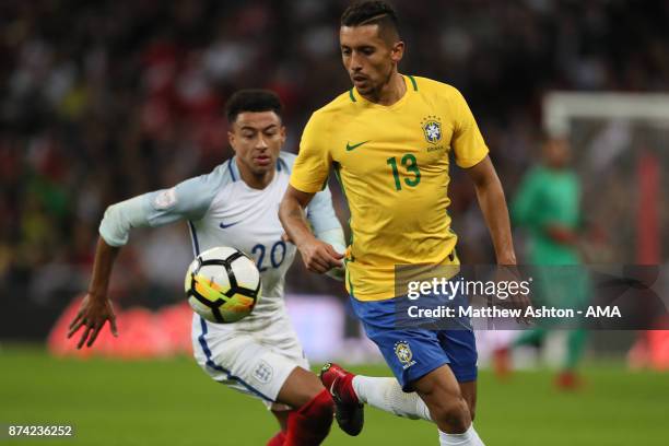 Jesse Lingard of England competes with Marquinhos of Brazil during the international friendly match between England and Brazil at Wembley Stadium on...