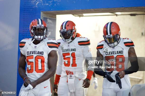 Bello, Jamie Collins and Christian Kirksey of the Cleveland Browns walks to the field prior to the game against the Detroit Lions at Ford Field on...