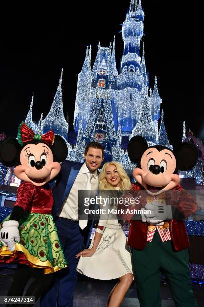 Julianne Hough and Nick Lachey pose with Mickey Mouse and Minnie Mouse at Magic Kingdom Park in Lake Buena Vista, Fla., Sunday, Nov. 5 while hosting...