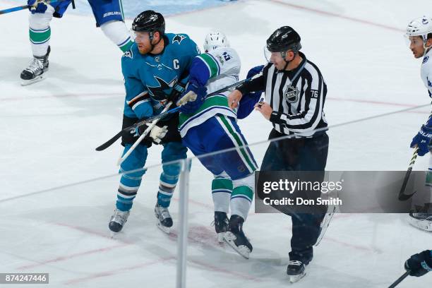 Joe Pavelski of the San Jose Sharks faces off against Derek Dorsett of the Vancouver Canucks at SAP Center on November 11, 2017 in San Jose,...