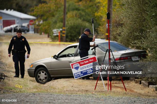 Law enforcement officers examine a vehicle that was involved in a shooting on November 14 in Rancho Tehama, California. Four people were killed and...